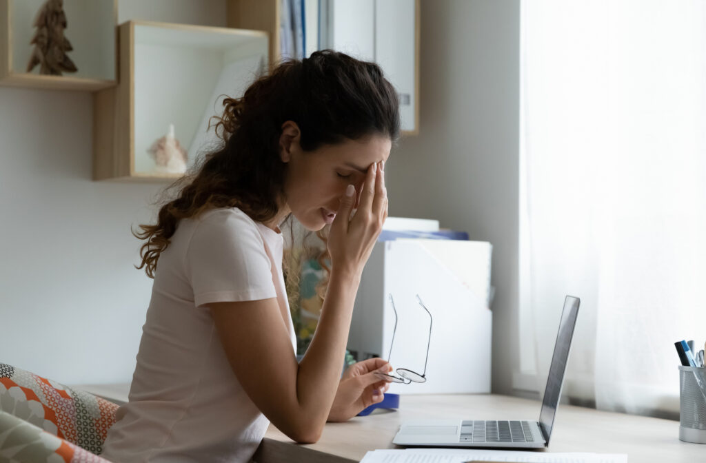 Women experiencing dry eyes due to excessive use of computer
