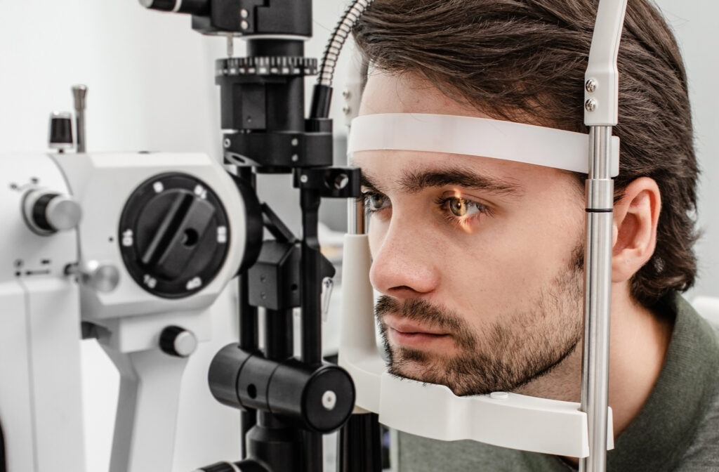 Young man undergoing eye exam at optometrists office