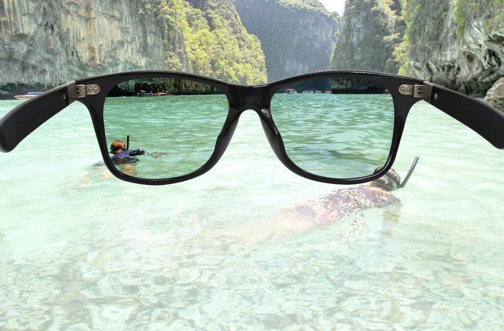 POV of person using polarized sunglasses to look at lake to protect eyes from UV 