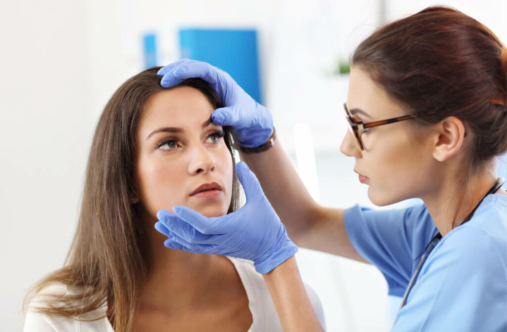 A young lady getting her eye checked by a female eye doctor.