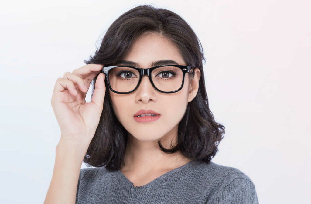 A beautiful woman wearing eye glasses to help with dry eye.