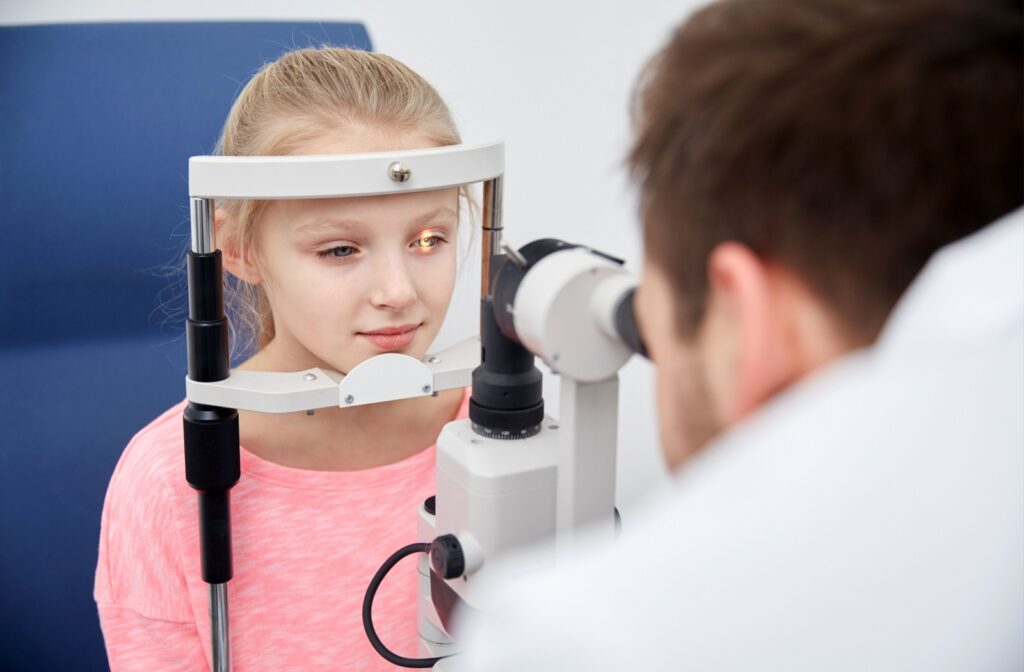 Small child getting slit lamp examination from their optometrist