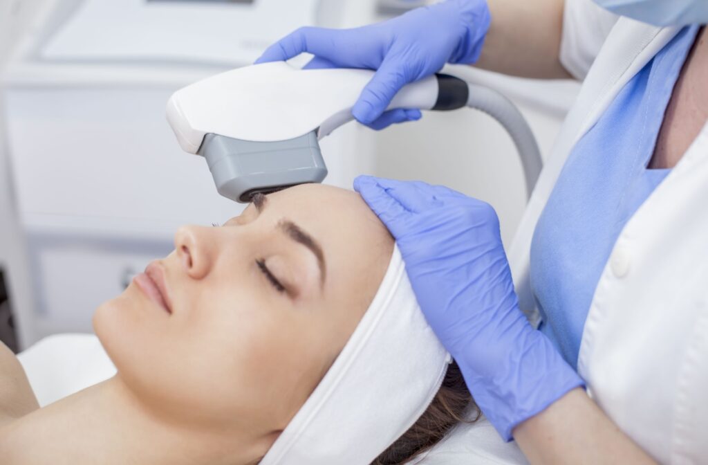 A woman receiving a photorejuvenation treatment in a clinic.