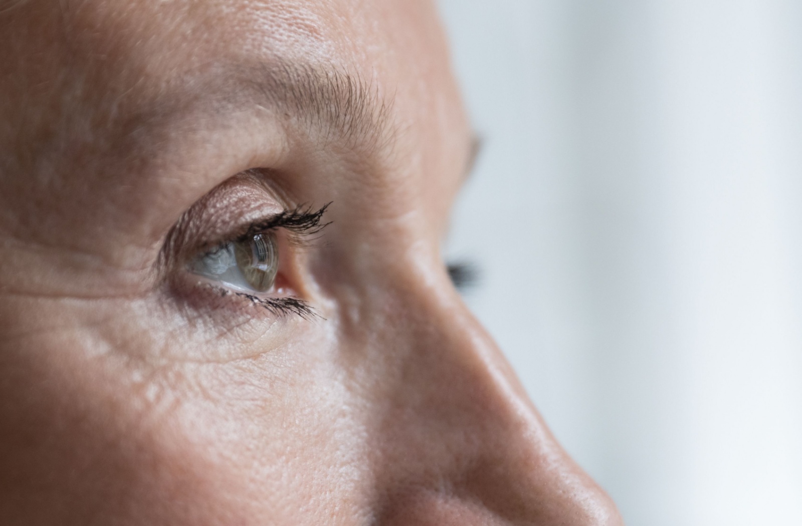 Close-up of a woman's eye showing detail of the iris and cornea, illustrating a concept related to astigmatism.